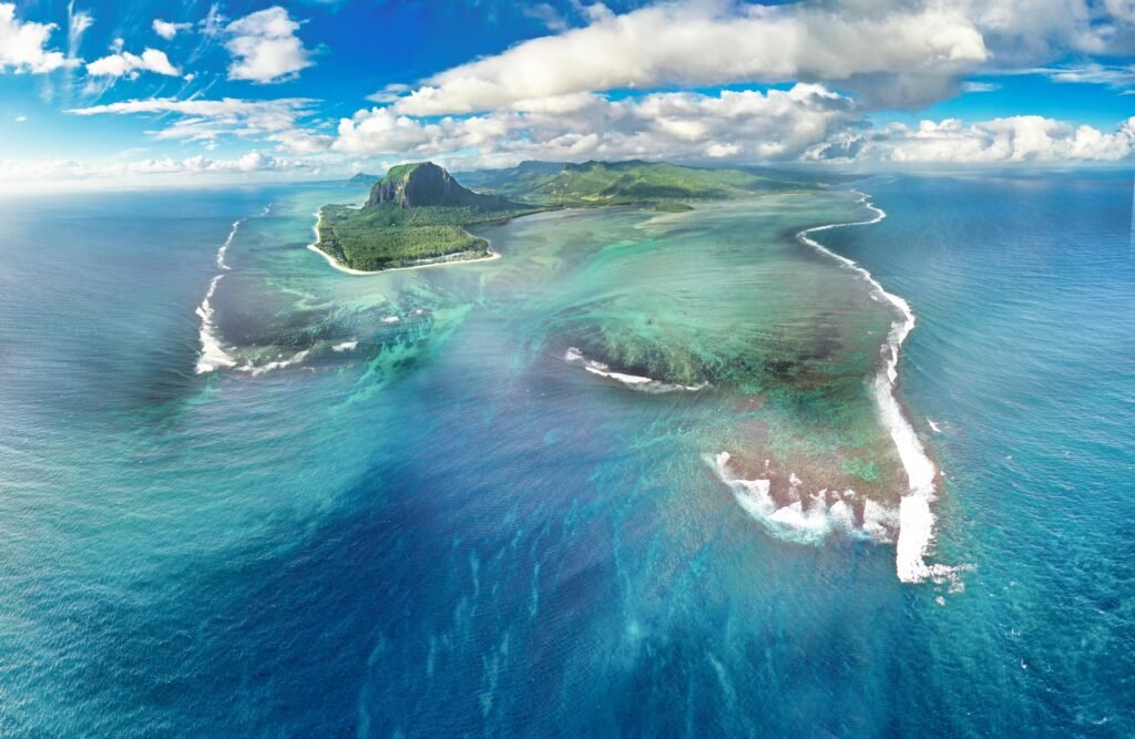 Explore the breathtaking Le Morne Peninsula, a UNESCO World Heritage site in Mauritius, from above.