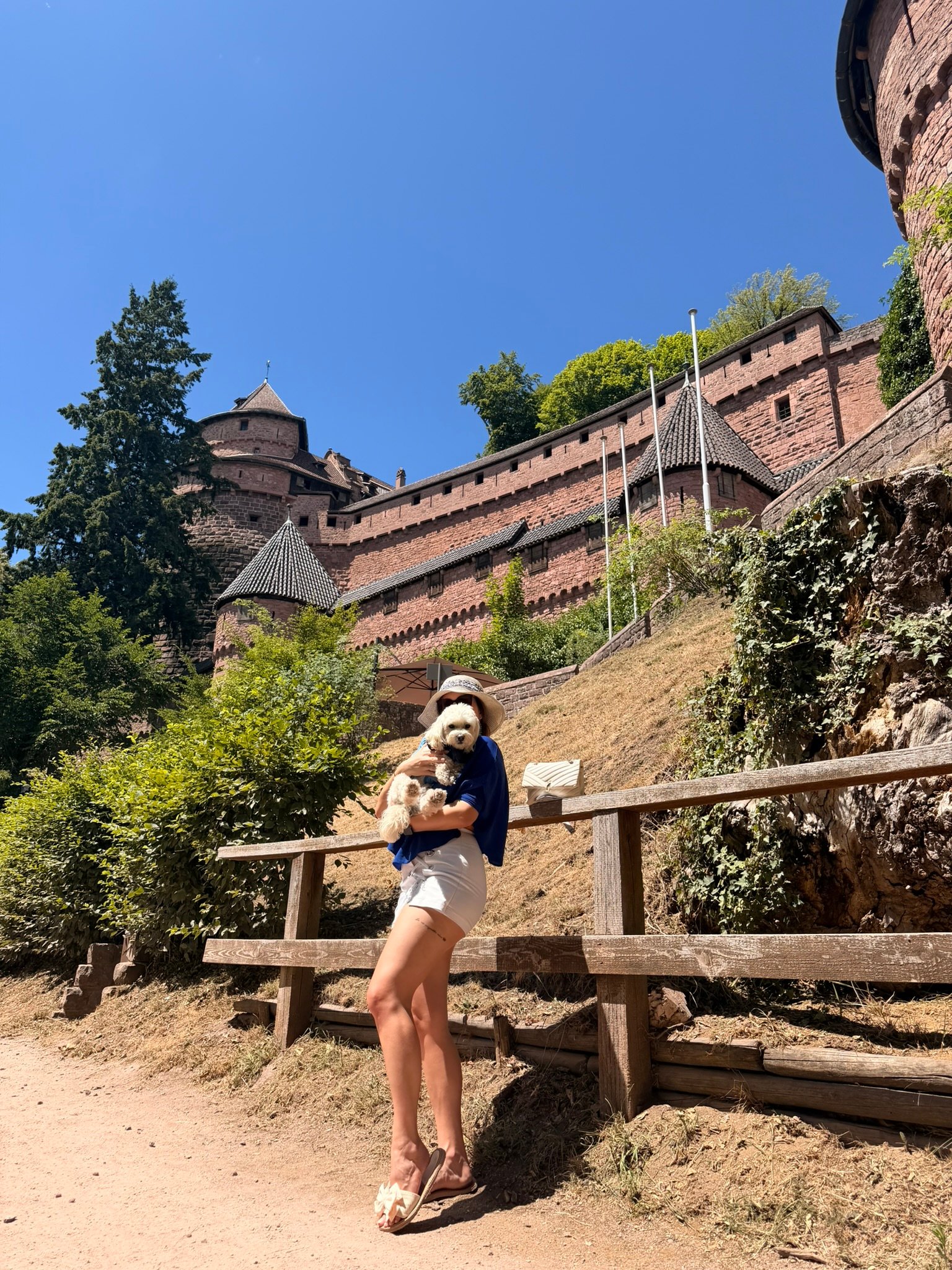 Elena and Cookie with the Château du Haut-Koenigsbourg in the background