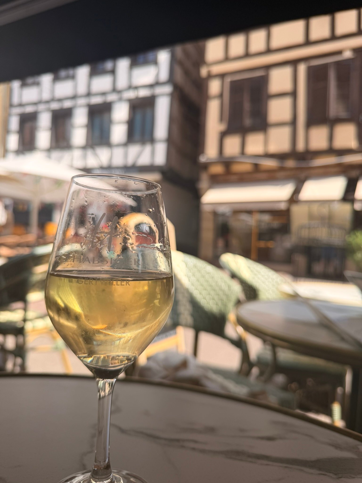 Glass of local wine and tarte flambée in Obernai